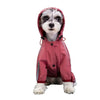 A small dog wearing a pink waterproof raincoat with reflective features.