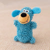 A bright blue plush dog toy with large ears and a black nose sitting on a light background.