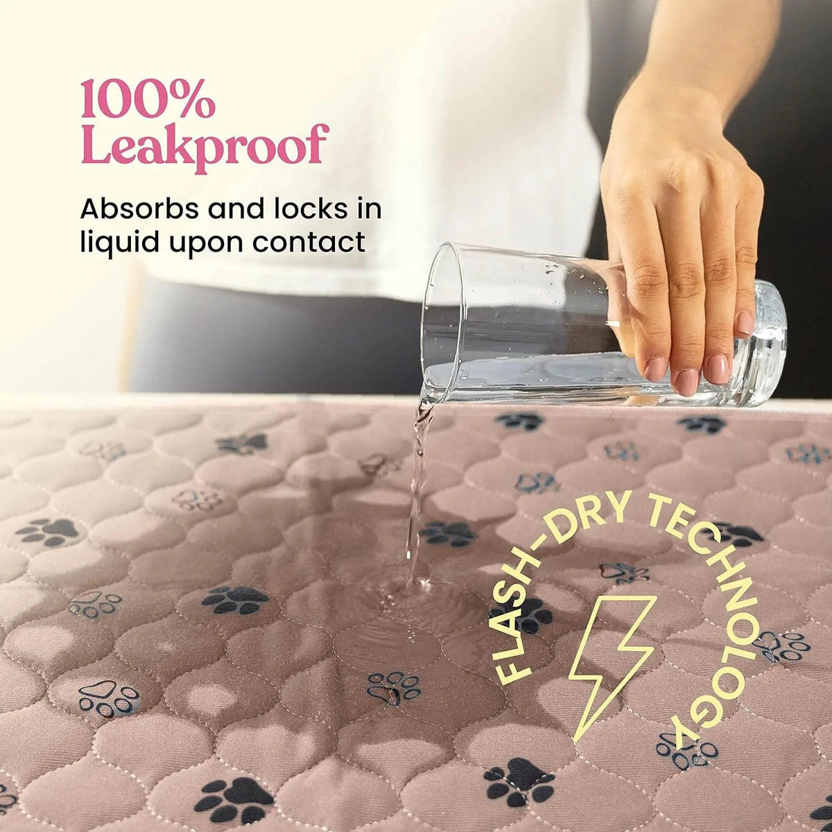 A clear glass is dripping liquid onto a pink quilted pad, demonstrating the leakproof and flash-dry technology of reusable do