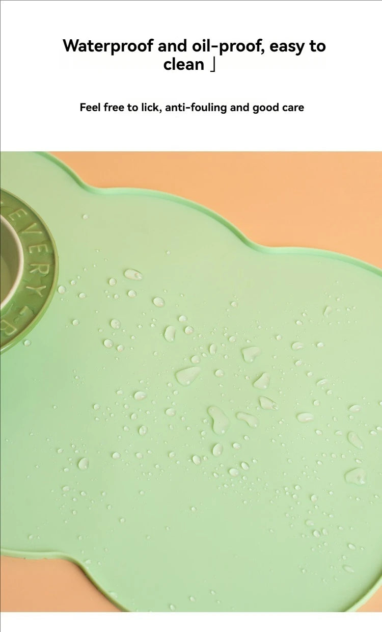 A light green silicone pet feeding mat with water droplets on its surface.