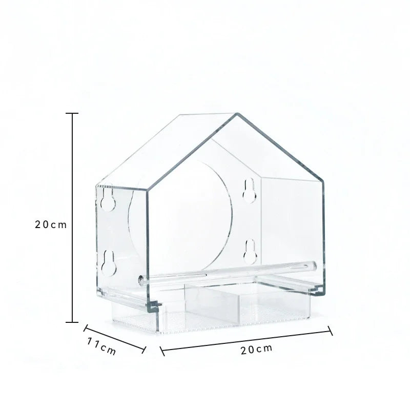Clear acrylic bird feeder with suction cups designed for window mounting.