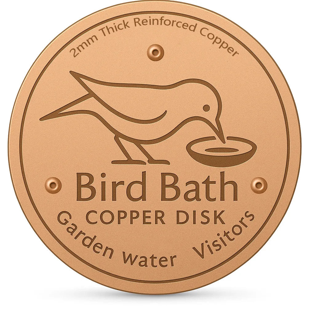 A round copper disk bird bath with a silhouette of a bird drinking water etched into it.