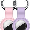 A silicone protective cover for an AirTag attached to a keychain, shown in pink and purple colors.