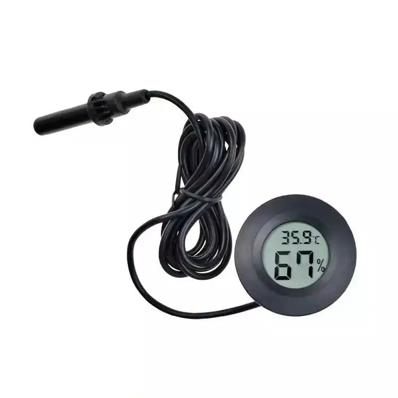 A black digital temperature and humidity monitor with a display showing 35.9°C and 67%.