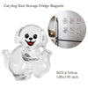 A clear glass figurine of a dog with a smiling face used as a fridge magnet for storing pet hair.
