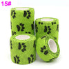 Rolls of bright lime green printed self-adhesive elastic bandage tape with black paw print pattern