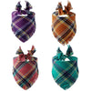 Four plaid dog bandanas in purple, orange, maroon, and teal colors with fringed edges