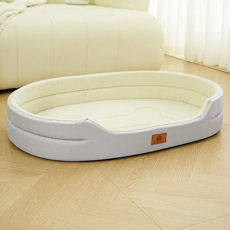 A light beige washable waterproof dog bed mat resting on a wooden floor next to a large cream-colored cushion.