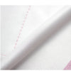 Close-up of a white waterproof reflective dog raincoat fabric showing a seam and texture.