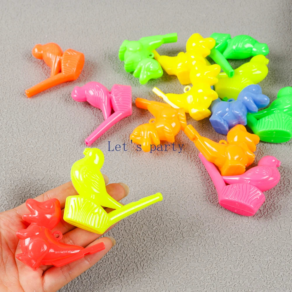 A hand holds a collection of colorful bird and dinosaur water whistles in various bright colors.