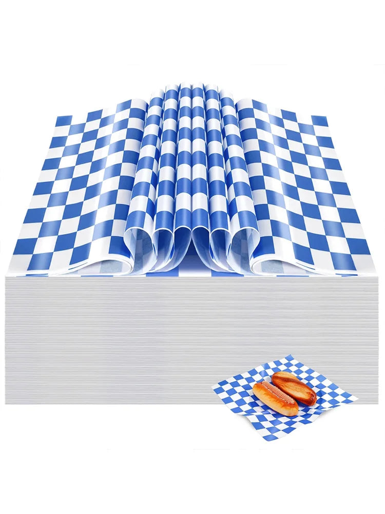 Rolls of blue and white checkered oil-proof sandwich wrapping paper stacked on a white surface.