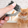 A hand holds a metal grooming comb and brush set near an orange tabby cat.