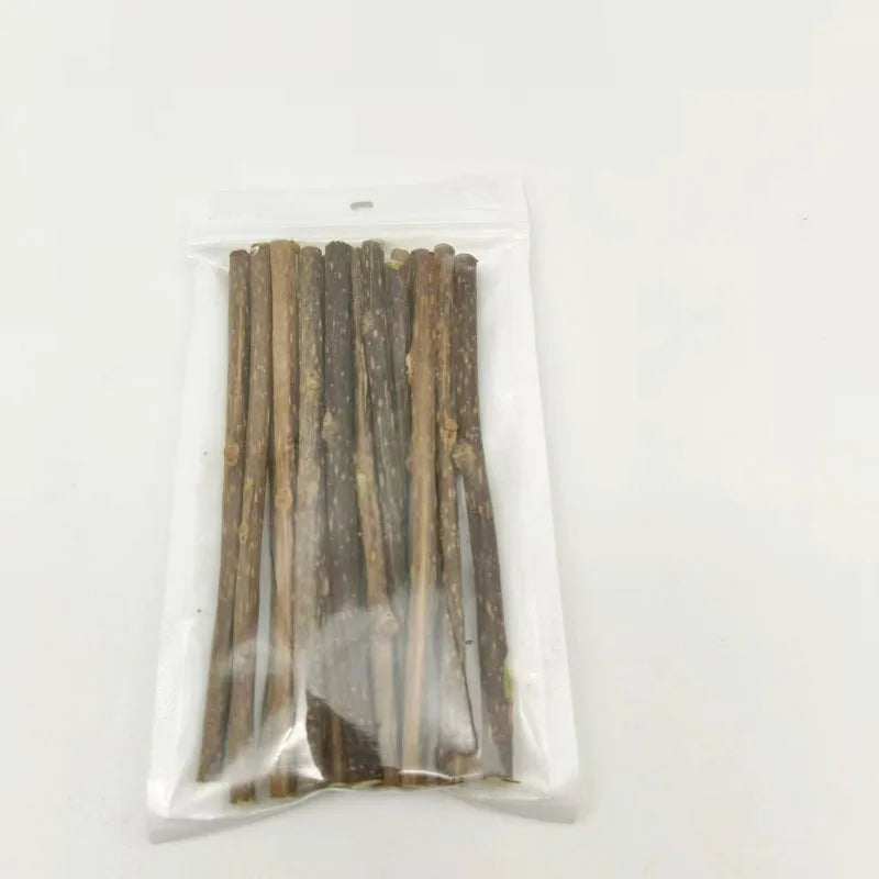 A clear plastic bag containing several natural herbal cat chew sticks.