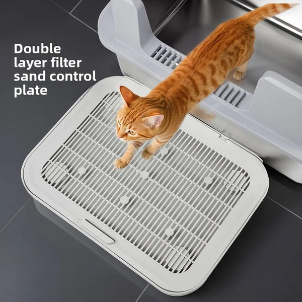 A tabby cat is jumping onto a white double layer filter sand control plate for litter box use.