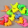 A collection of ten colorful bird and dinosaur water whistles in various bright colors like yellow, green, orange, and pink.