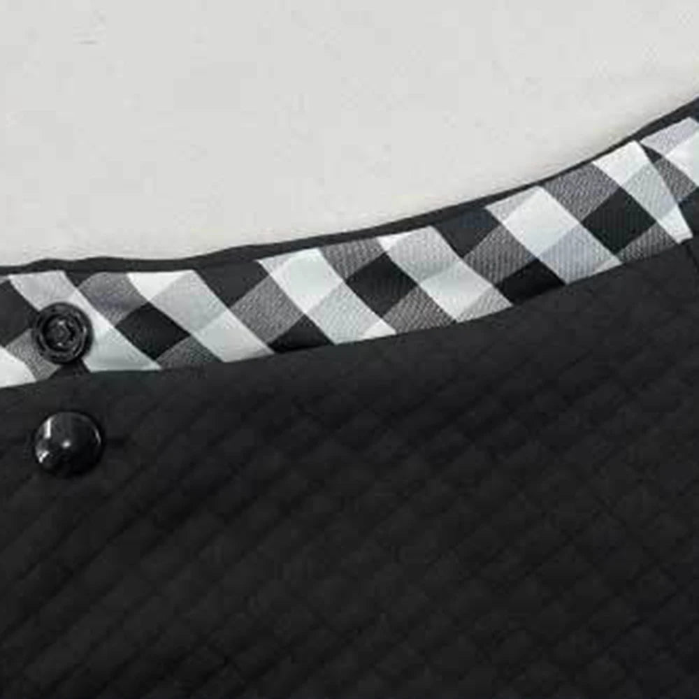Close-up of a black fabric pet carrier bag featuring a black and white checkered trim.