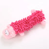 A pink plush toy resembling a lizard with a spiky, textured body and a smiling face.