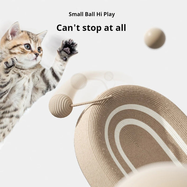 A kitten is playing with a small ball toy near a woven sisal cat scratcher board.