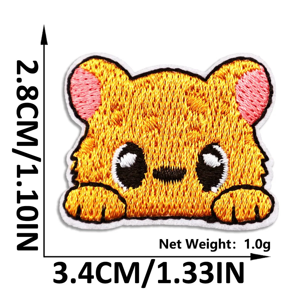 An embroidered patch of a cute, orange cat face with white accents on a white background.