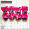 A set of bright pink breathable soft sole shoes for dogs with adjustable straps