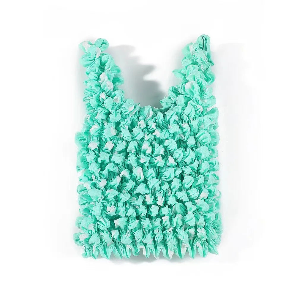 A vibrant turquoise reusable foldable bubble shopping bag with a ruffled texture.