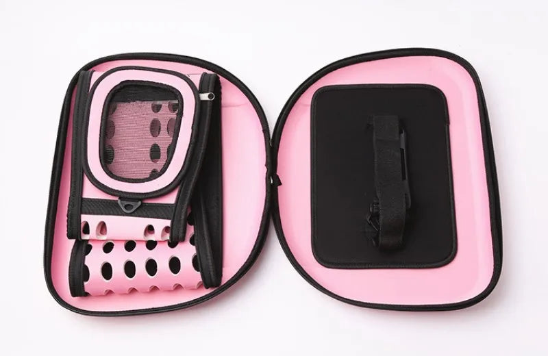 Pink and black breathable pet carrier backpack for cats and small dogs shown open with accessories.