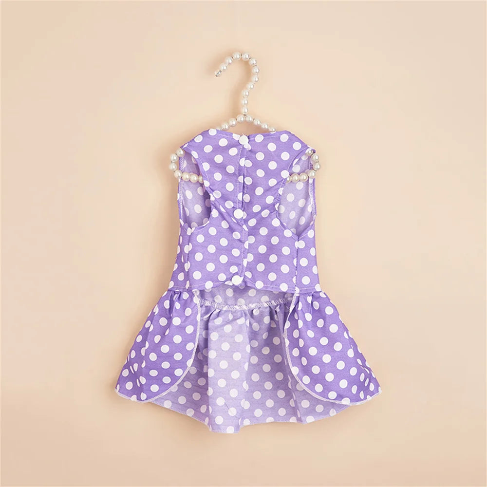 A purple polka dot dog dress for a small breed, featuring a lightweight summer skirt and pearl-trimmed straps.