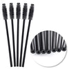 A set of disposable black eyelash and eyebrow brushes with long handles.