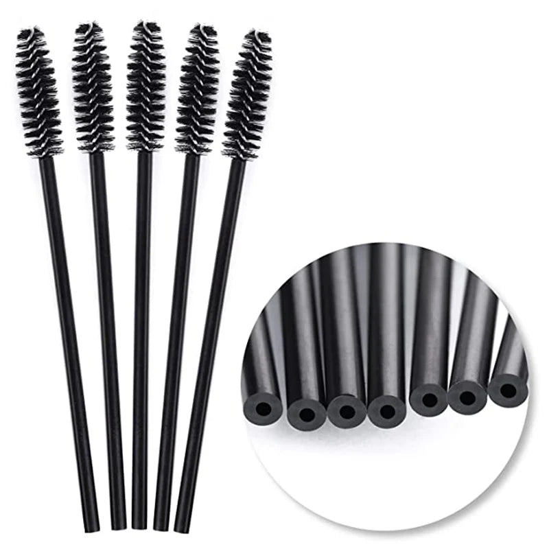 A set of disposable black eyelash and eyebrow brushes with long handles.
