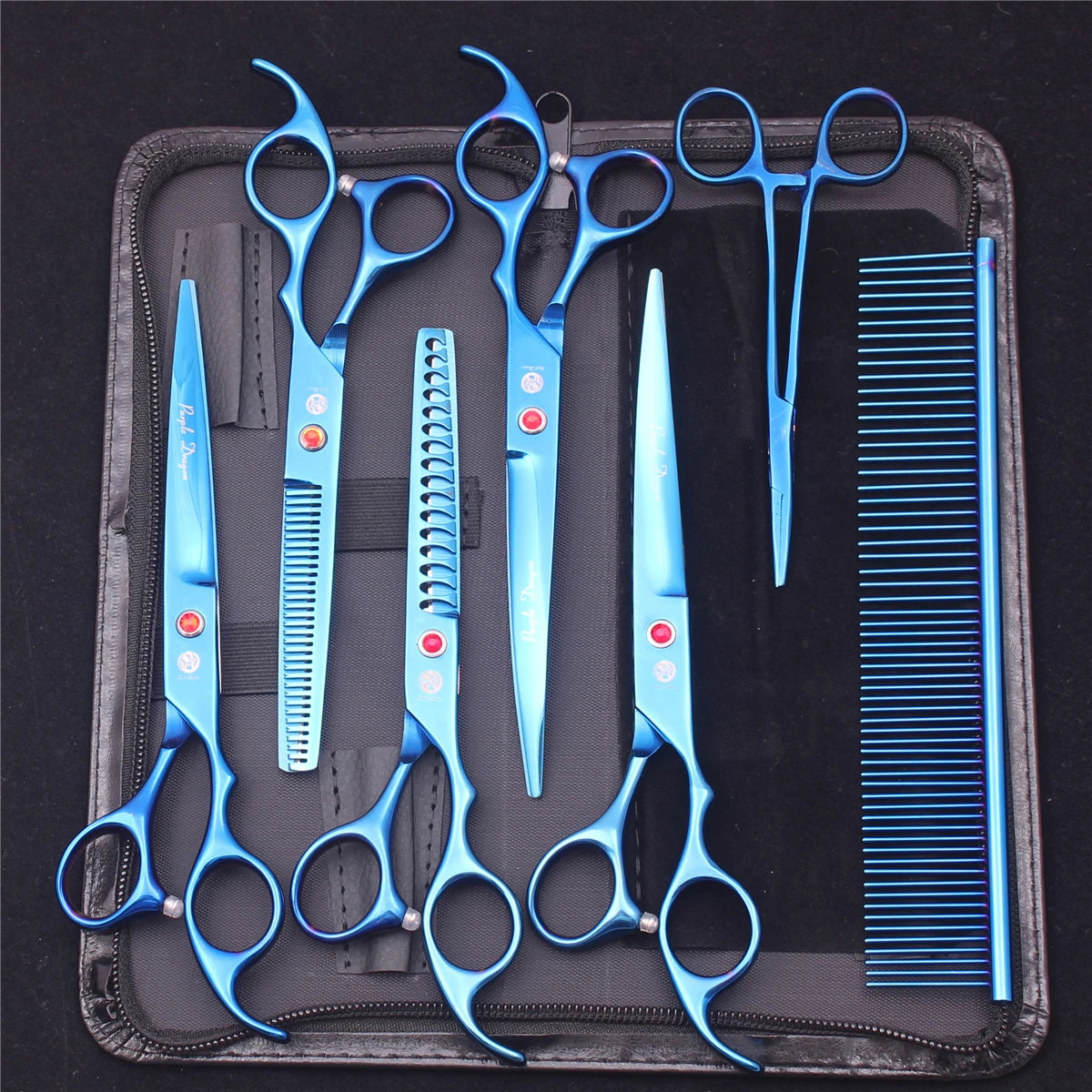 A set of professional stainless steel pet grooming scissors, combs, and brushes laid out on a black case.