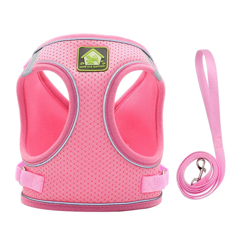 Pink adjustable mesh dog harness with reflective strips and a pink leash