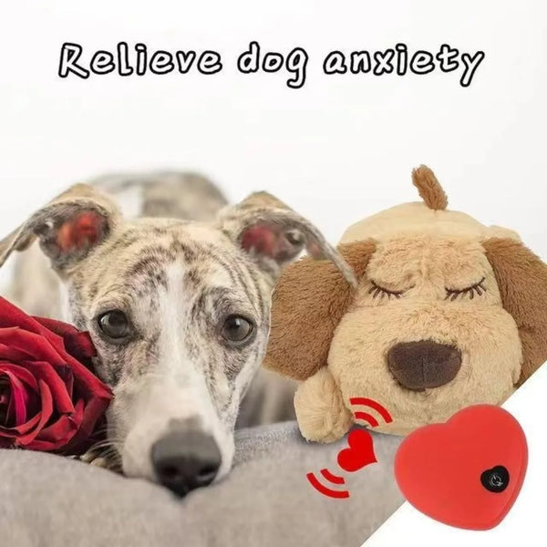 A soft, brown dog fidget toy is shown resting on a gray fabric, with a red heart placed nearby.