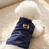 A navy blue sleeveless vest for a pet with white fluffy fur, featuring a cartoon embroidery.