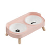 A pink stainless steel double bowl for dogs and cats with two white bowls.