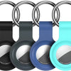 A silicone airtag protective cover is shown attached to a metal keychain ring in various colors: black, gray, blue, and cyan.