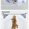 A small rodent is resting inside a fluffy, purple and white plush hammock.