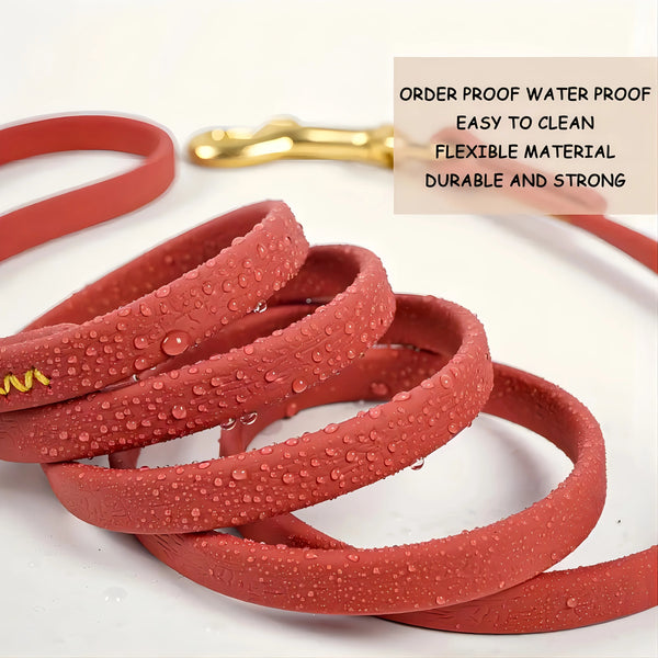 Red waterproof dog leash coiled on a white background with water droplets visible.