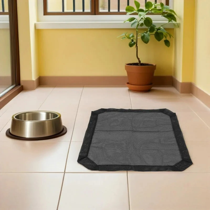 A black breathable mesh replacement cover for an elevated pet bed placed on a tiled floor.