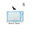 A rectangular white pet training pad with light blue edges and a silhouette of a dog above it.
