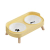 A light yellow stainless steel double bowl for dogs and cats with two ceramic bowls inside.
