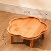 A wooden ceramic slow feeder cat bowl with a stand, showing its size and texture.