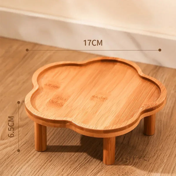 A wooden ceramic slow feeder cat bowl with a stand, showing its size and texture.