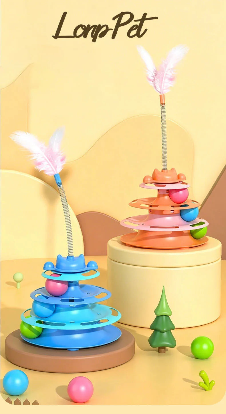 A colorful interactive cat turntable toy with a feather wand and rolling balls displayed on a light yellow surface.