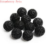 A collection of black strawberry pets, which are bio balls used for water filtration.
