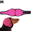 Pink noise cancelling dog ear wrap placed on a brown dog's head.