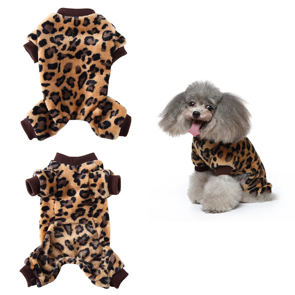 A small dog wearing a brown and black leopard print cozy winter outfit or overalls.