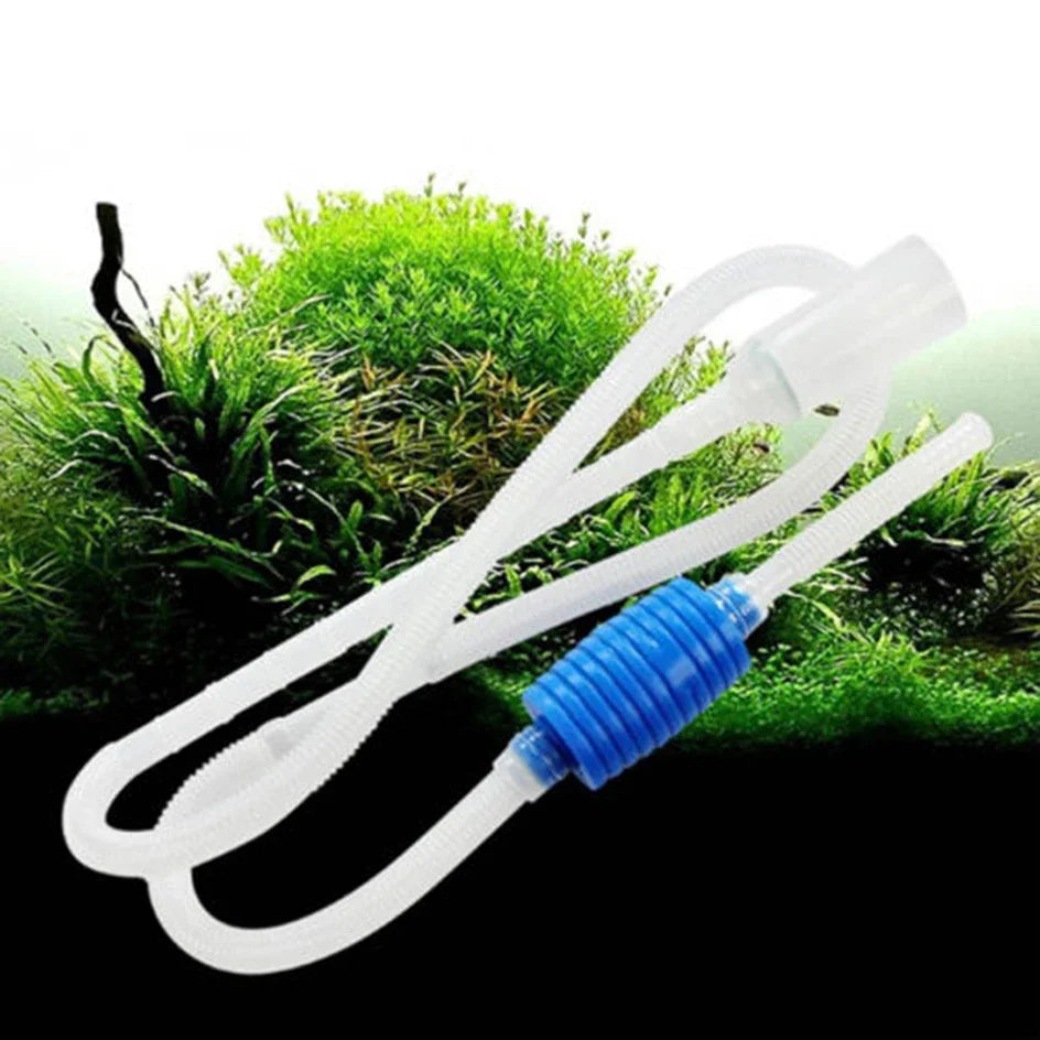 White flexible siphon cleaner tubing with a blue connector lying on green grass.