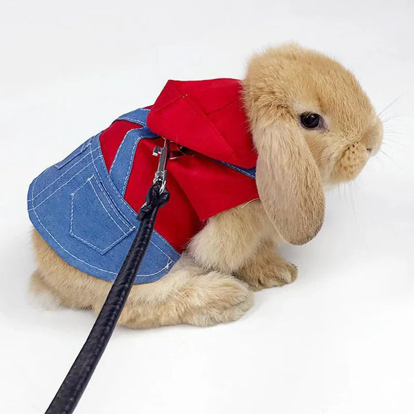 A fluffy rabbit toy wearing a denim vest and a red collar.