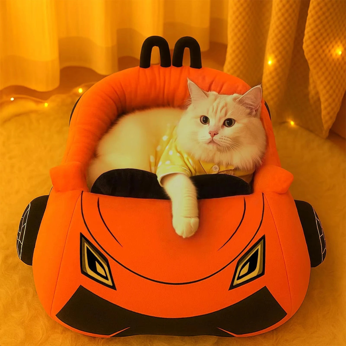 A fluffy white cat is relaxing inside an orange pumpkin-shaped pet bed.