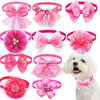 A collection of pink lace bowtie collar accessories for small dogs and cats, including bows and floral shapes.